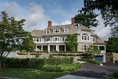 Example of a huge beach style gray three-story mixed siding house exterior design in Other with a hip roof and a shingle roof