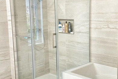 Inspiration for a mid-sized contemporary master gray tile and ceramic tile ceramic tile and gray floor bathroom remodel in Montreal with flat-panel cabinets, white cabinets, gray walls, a drop-in sink and solid surface countertops