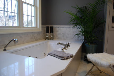 Inspiration for a mid-sized transitional master gray tile, white tile and marble tile marble floor and white floor corner shower remodel in Philadelphia with flat-panel cabinets, gray cabinets, an undermount tub, a one-piece toilet, gray walls, an undermount sink, quartzite countertops and a hinged shower door
