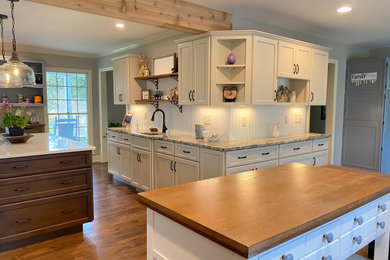 Inspiration for a huge farmhouse brown floor kitchen remodel in New York with shaker cabinets, blue backsplash, stainless steel appliances and two islands
