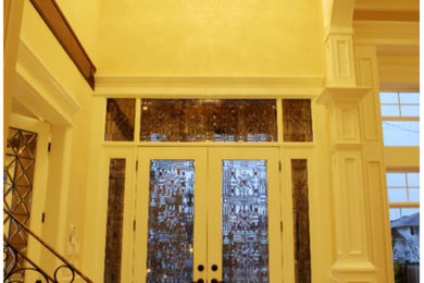 Example of a marble floor entryway design in Vancouver with a white front door