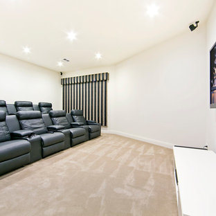 Home theater - mid-sized modern enclosed carpeted home theater idea in Adelaide with white walls and a wall-mounted tv