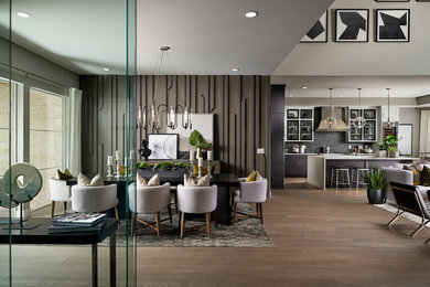 Example of a trendy medium tone wood floor and brown floor great room design in Denver with brown walls
