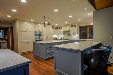 Eat-in kitchen - large modern u-shaped eat-in kitchen idea in Portland with a drop-in sink, shaker cabinets, blue cabinets, quartzite countertops, an island and white countertops