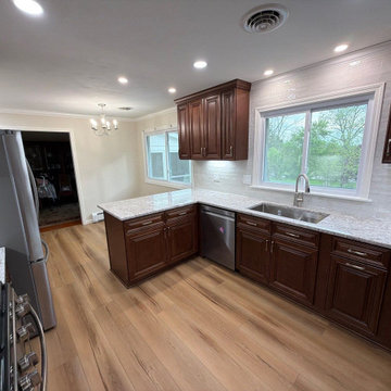USCD cabinetry accompanied granite countertops, porcelain tile backsplash and Ca