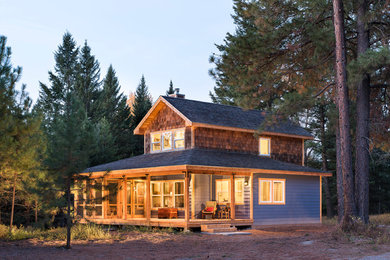 Example of a small mountain style blue two-story mixed siding gable roof design in Other