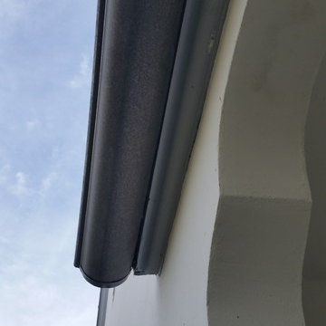 Bonderized Steel, 5 inch Half Round Seamless Gutters with Round Downspouts.