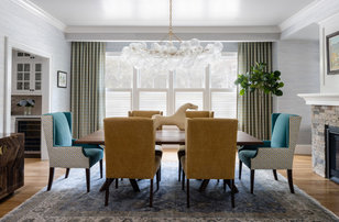 Large transitional light wood floor, brown floor, tray ceiling and wallpaper kitchen/dining room combo photo in Boston with blue walls, a two-sided fireplace and a stacked stone fireplace
