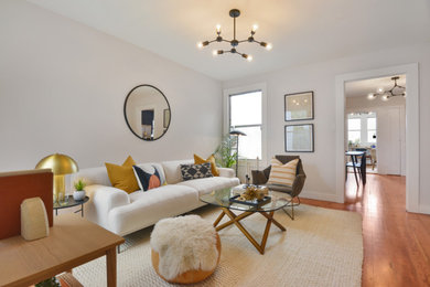 Mid-sized elegant enclosed medium tone wood floor living room photo in San Francisco with white walls