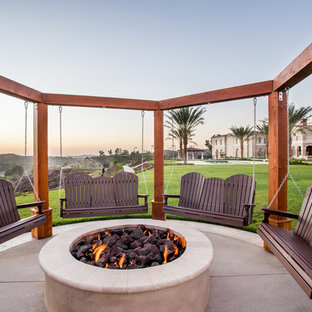 Transitional backyard patio in Orange County with a fire feature, concrete slab and no cover.