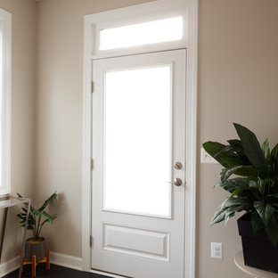 Inredning av en eklektisk mellanstor foajé, med grå väggar, laminatgolv, en enkeldörr, en svart dörr och svart golv