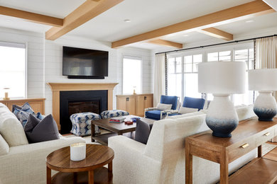 Living room - farmhouse open concept light wood floor, exposed beam and shiplap wall living room idea in Milwaukee with a standard fireplace, a wood fireplace surround and a wall-mounted tv