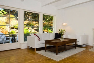 Example of a large transitional formal and enclosed medium tone wood floor living room design in St Louis with white walls, no fireplace and no tv