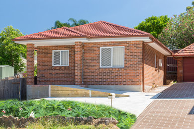 Photo of a small contemporary one-storey brick brown exterior in Sydney.