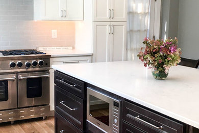 Eat-in kitchen - mid-sized transitional u-shaped beige floor eat-in kitchen idea with recessed-panel cabinets, white cabinets and an island