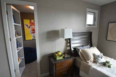 Example of a mid-sized trendy guest carpeted bedroom design in Other with gray walls and no fireplace