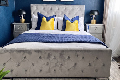 他の地域にある中くらいなミッドセンチュリースタイルのおしゃれな主寝室 (青い壁、カーペット敷き、茶色い床、壁紙) のレイアウト