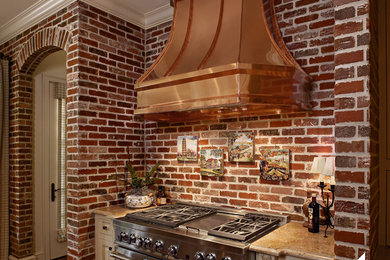 Example of a large mountain style kitchen design in Other with beaded inset cabinets, distressed cabinets, red backsplash and brick backsplash