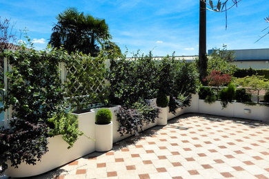 This is an example of a large contemporary rooftop deck in Milan with a container garden and a roof extension.