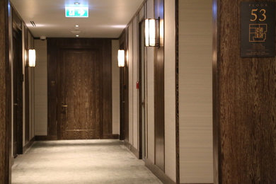 Inspiration for a small timeless carpeted and beige floor entryway remodel in Other with brown walls and a brown front door