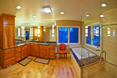 Large transitional master beige tile and ceramic tile light wood floor and brown floor bathroom photo in Denver with shaker cabinets, medium tone wood cabinets, beige walls, an undermount sink, granite countertops, a two-piece toilet and a hinged shower door