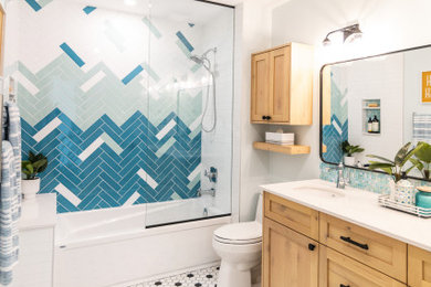 Bathroom - mid-sized coastal kids' multicolored tile multicolored floor and double-sink bathroom idea in Calgary with shaker cabinets, light wood cabinets, blue walls, an undermount sink, quartz countertops, white countertops and a built-in vanity