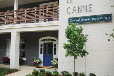 Large trendy white two-story brick exterior home photo in New Orleans