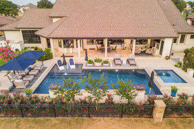 Transitional backyard stone and rectangular pool photo in Austin