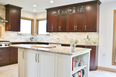 Example of a mid-sized transitional u-shaped porcelain tile and beige floor eat-in kitchen design in Chicago with an undermount sink, flat-panel cabinets, brown cabinets, quartz countertops, beige backsplash, travertine backsplash, stainless steel appliances and an island