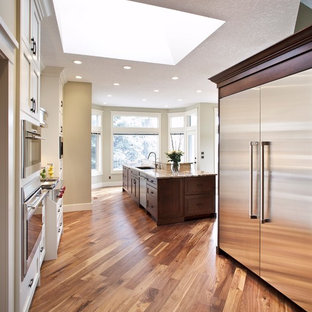 Huge transitional kitchen pantry remodeling - Inspiration for a huge transitional single-wall light wood floor kitchen pantry remodel in Calgary with a double-bowl sink, shaker cabinets, dark wood cabinets, granite countertops, multicolored backsplash, mosaic tile backsplash, stainless steel appliances and an island