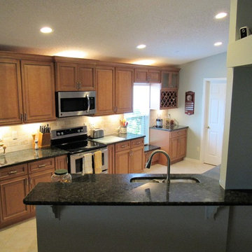 Galaxy Pecan cabinets with peacock green granite