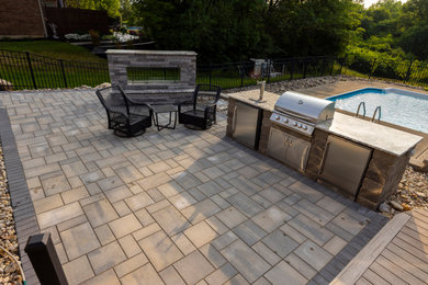 Example of a small transitional backyard concrete paver patio kitchen design in Cincinnati with no cover