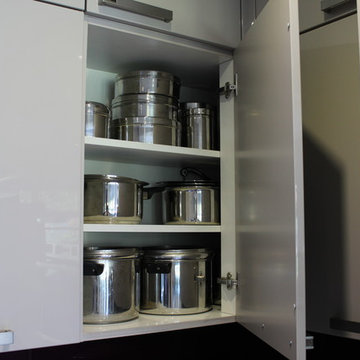 A German Kitchen with Glass Splashback in Stanmore by Kudos Interior Designs