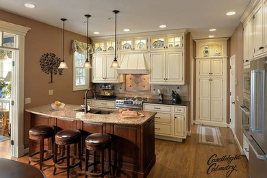 Inspiration for a l-shaped medium tone wood floor eat-in kitchen remodel in New York with an undermount sink, white cabinets, stainless steel appliances and an island