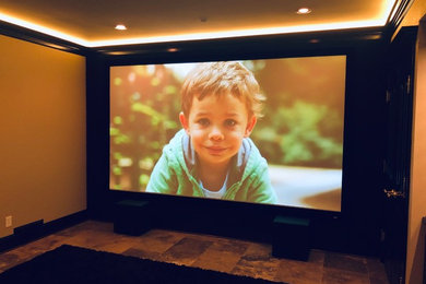 Example of a large enclosed ceramic tile home theater design in Seattle with a projector screen