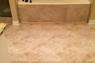 Example of a large classic master beige tile and ceramic tile ceramic tile bathroom design in Jackson with raised-panel cabinets, white cabinets, a two-piece toilet, beige walls, an undermount sink and granite countertops