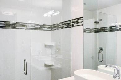 Inspiration for a large modern gray tile and stone tile mosaic tile floor walk-in shower remodel in Chicago with flat-panel cabinets, black cabinets, white walls, a wall-mount sink, quartz countertops and a two-piece toilet