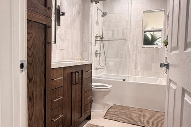 Example of a mid-sized minimalist beige tile and subway tile porcelain tile, beige floor and single-sink bathroom design in Los Angeles with raised-panel cabinets, brown cabinets, beige walls, a drop-in sink, quartz countertops, a built-in vanity, white countertops and a niche