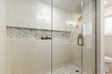 Large minimalist master beige tile and porcelain tile pebble tile floor wet room photo in Seattle with a hinged shower door