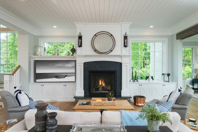 Inspiration for a contemporary medium tone wood floor and shiplap ceiling living room remodel in Boston with a stacked stone fireplace and a wall-mounted tv