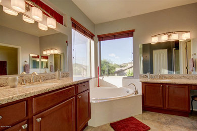 Inspiration for a mid-sized timeless master beige tile and ceramic tile ceramic tile bathroom remodel in Phoenix with an undermount sink, recessed-panel cabinets, granite countertops, a one-piece toilet and beige walls