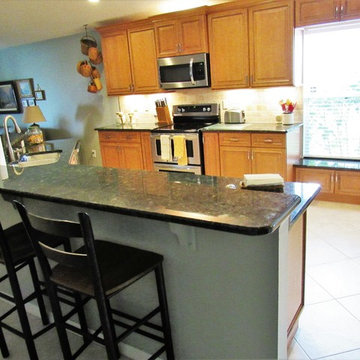 Galaxy Pecan cabinets with peacock green granite