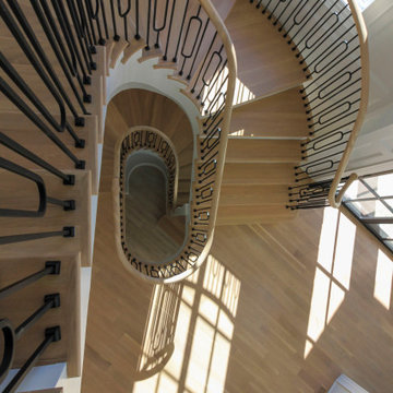 Project #95 | Freestanding Elliptical Staircase with Geometric Iron Balusters