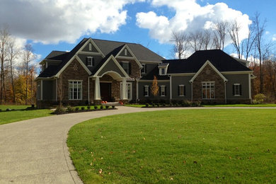 Large traditional multicolored two-story mixed siding exterior home idea in Cleveland with a shingle roof