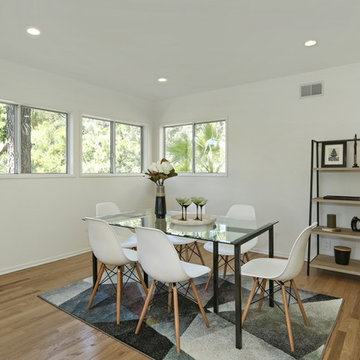 Eames replica chairs, Crate & Barrel dining table, edgy rug
