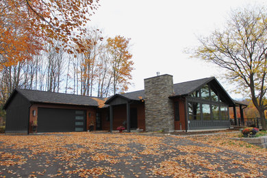 Large modern one-story metal house exterior idea in Other with a shingle roof and a gray roof
