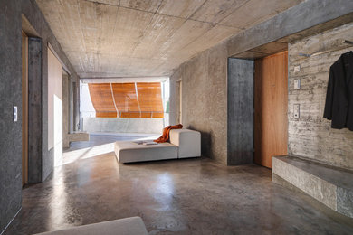 Photo of a modern living room in Other with concrete floors.