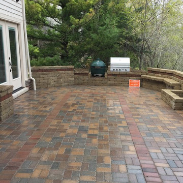 Outdoor Kitchen with  fireplace, dining area and seating wall