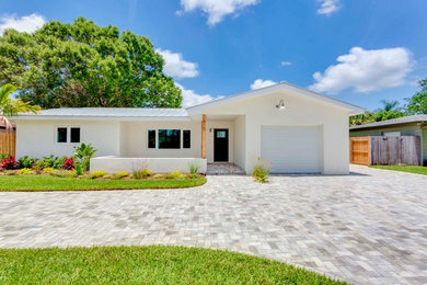 White one-story exterior home idea in Tampa with a metal roof