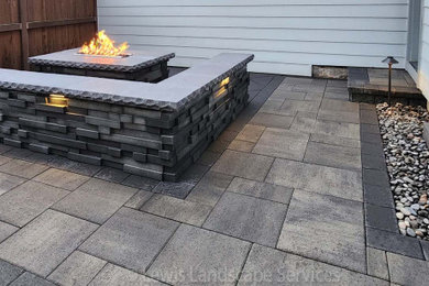 Patio - modern courtyard concrete paver patio idea in Portland with a fire pit